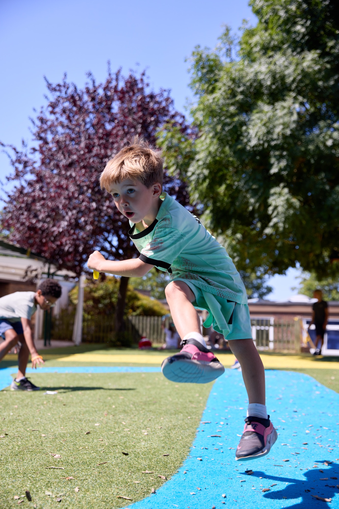 Child leaping mid-air during an outdoor activity session