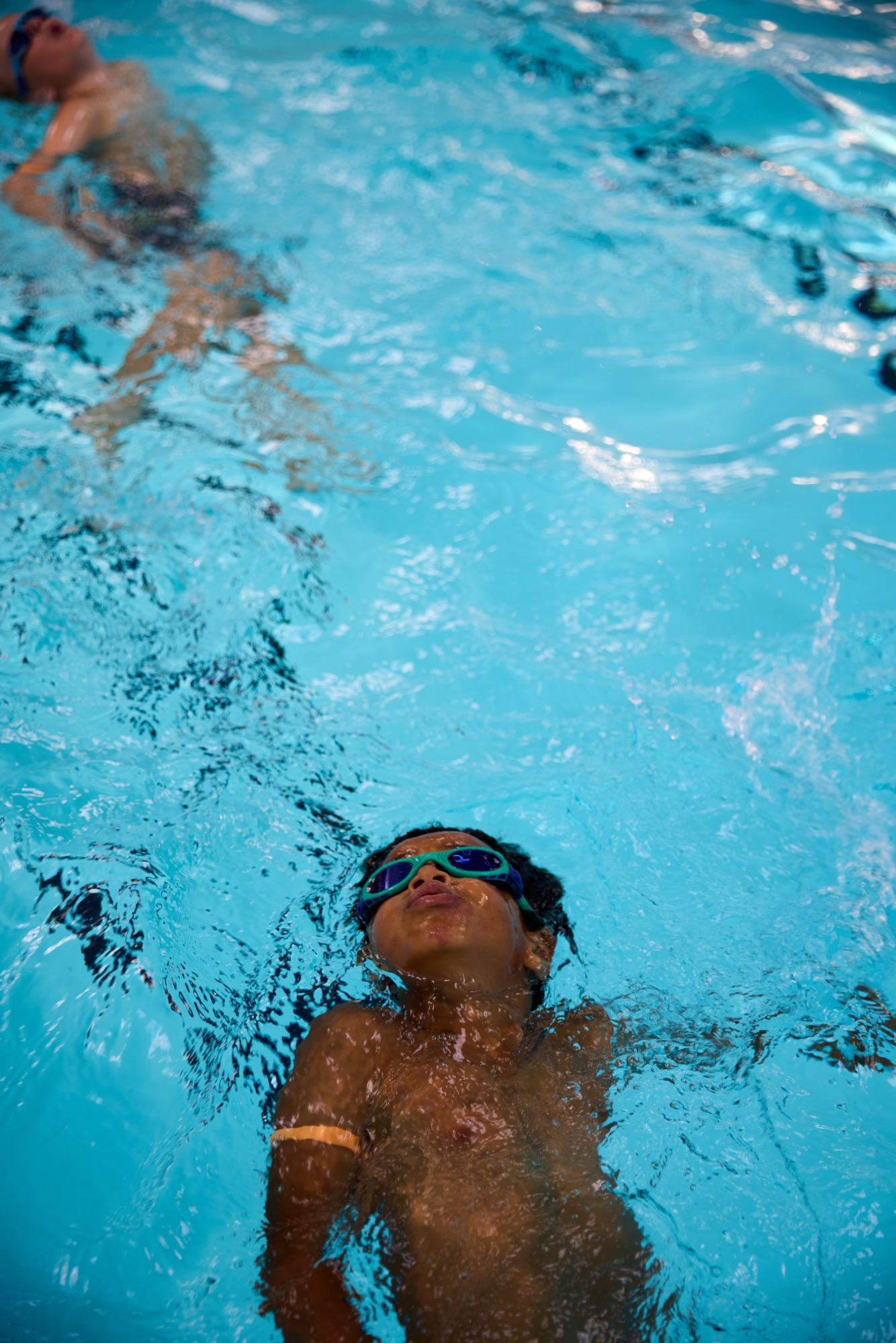 Child swimming, overhead view