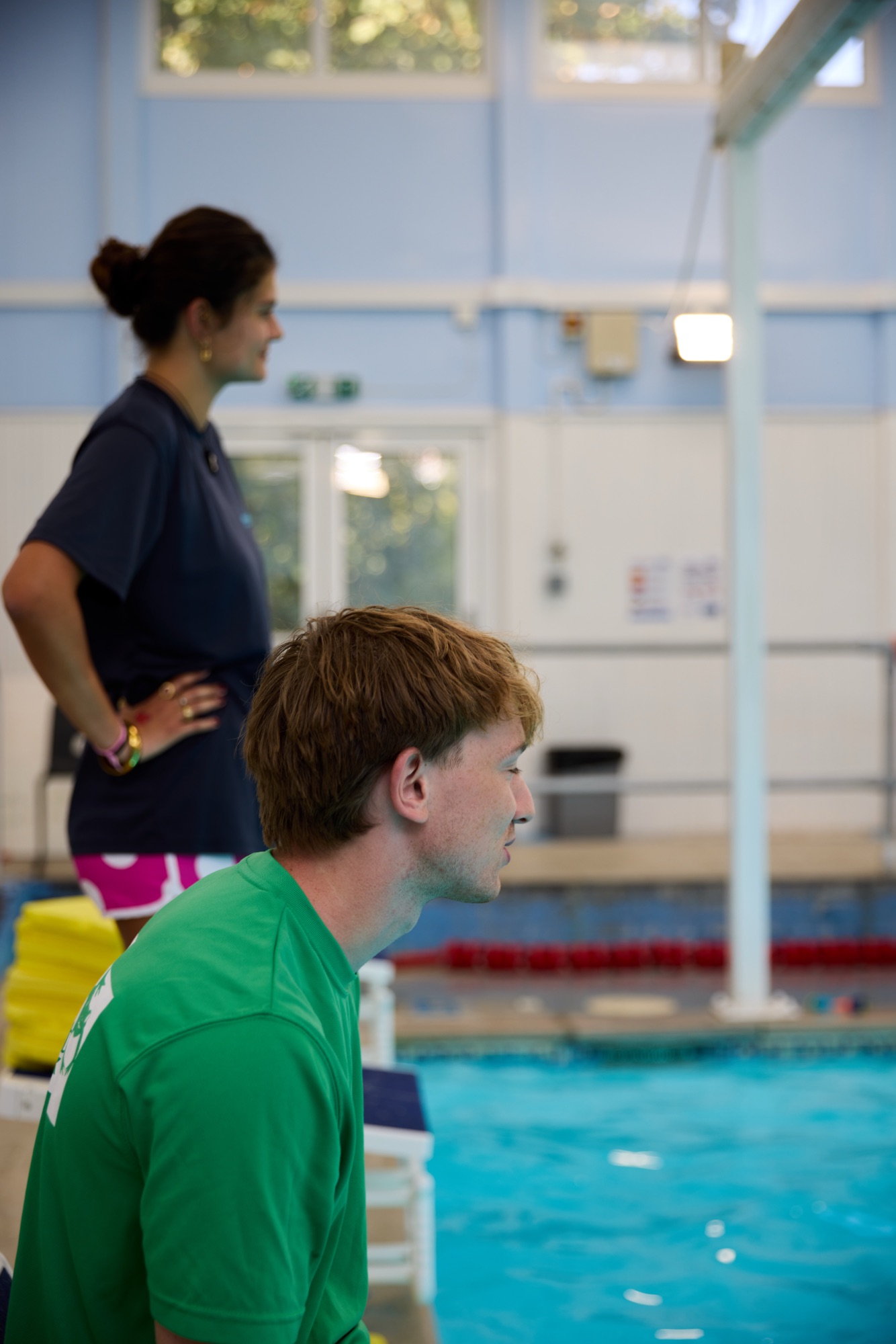Two staff members poolside