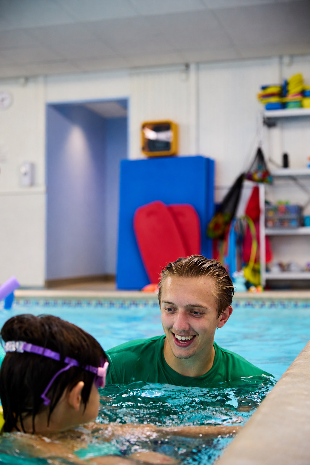 Instructor smiling with a young swimmer