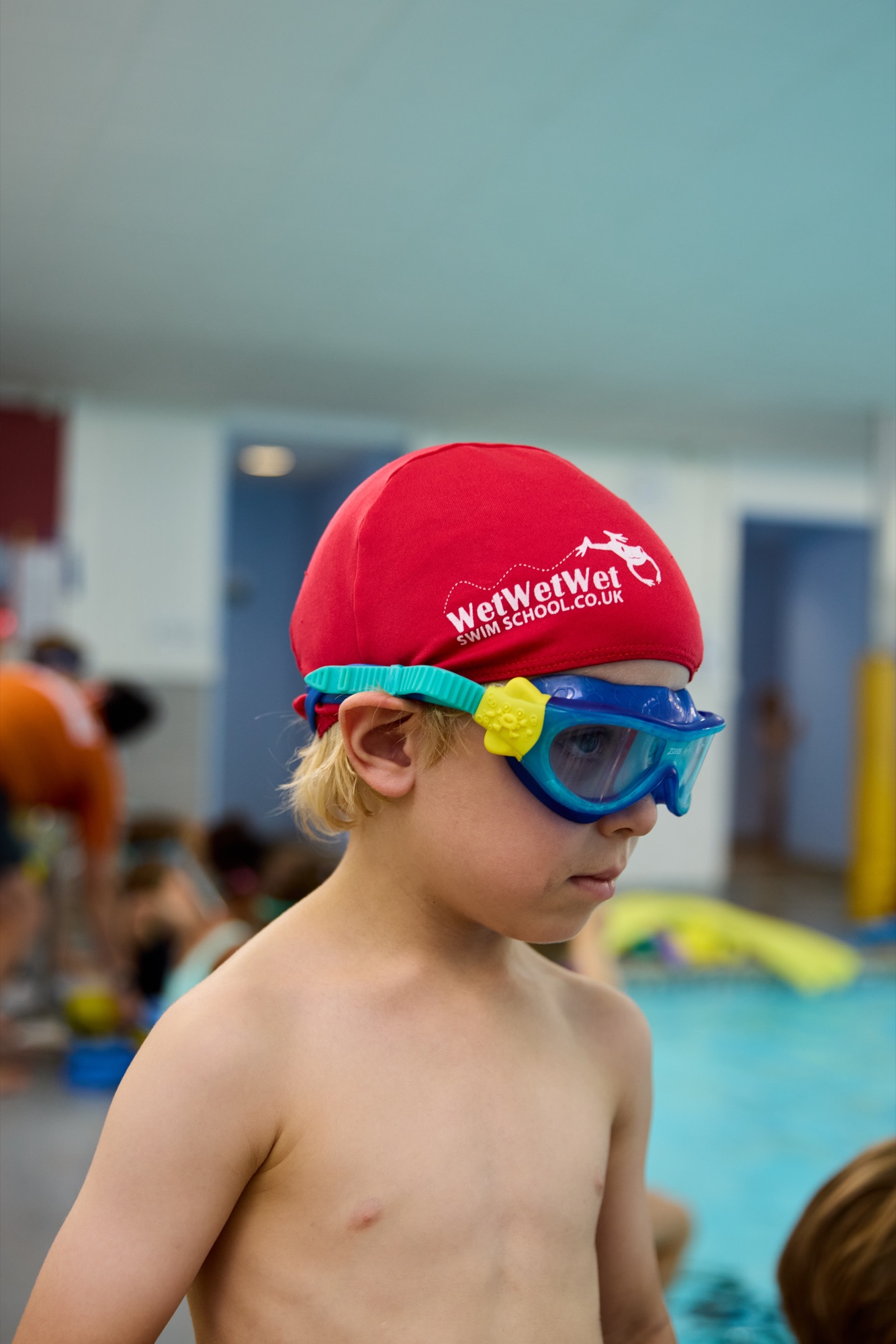 Boy in red swim cap, profile portrait