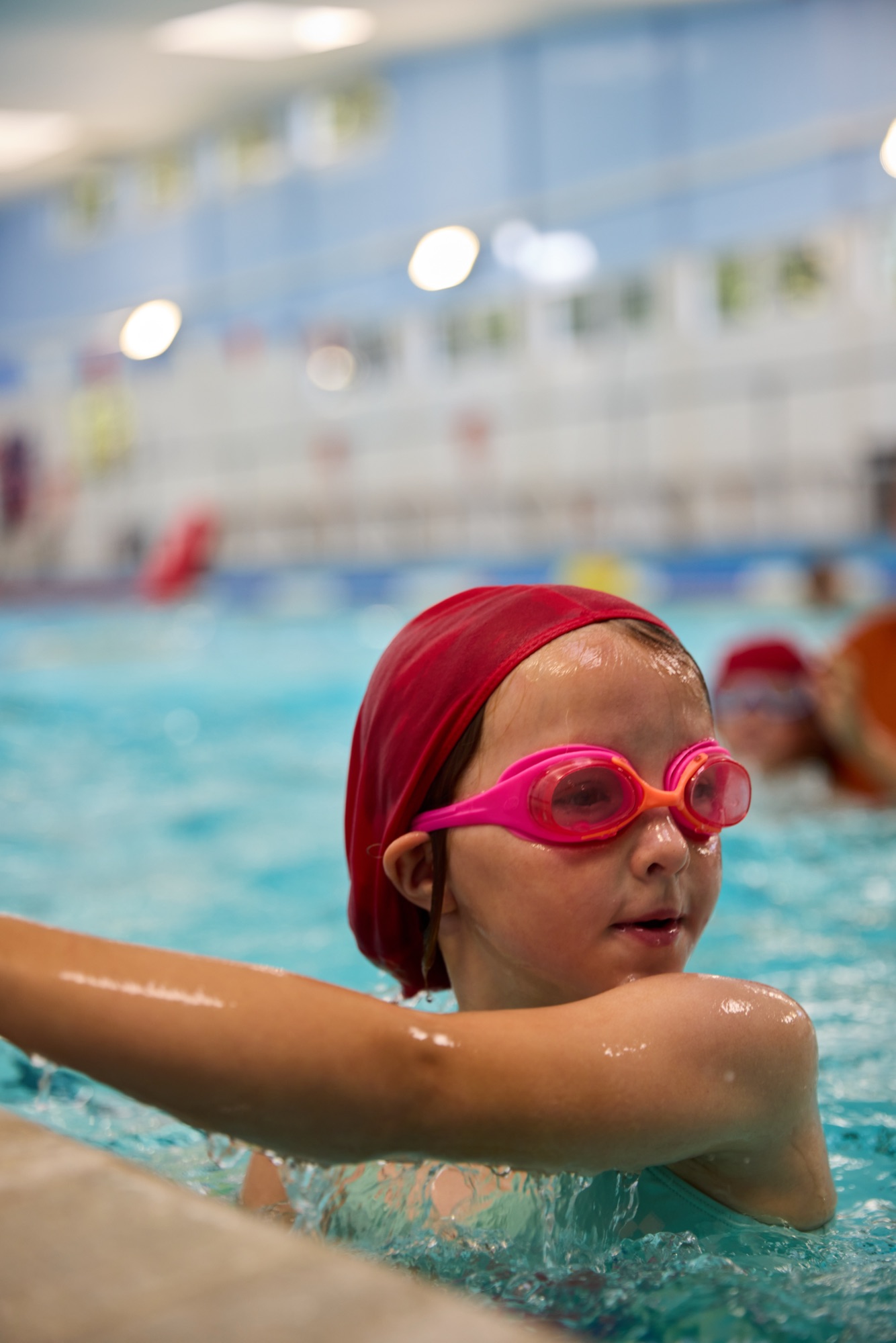 Girl resting at the pool wall